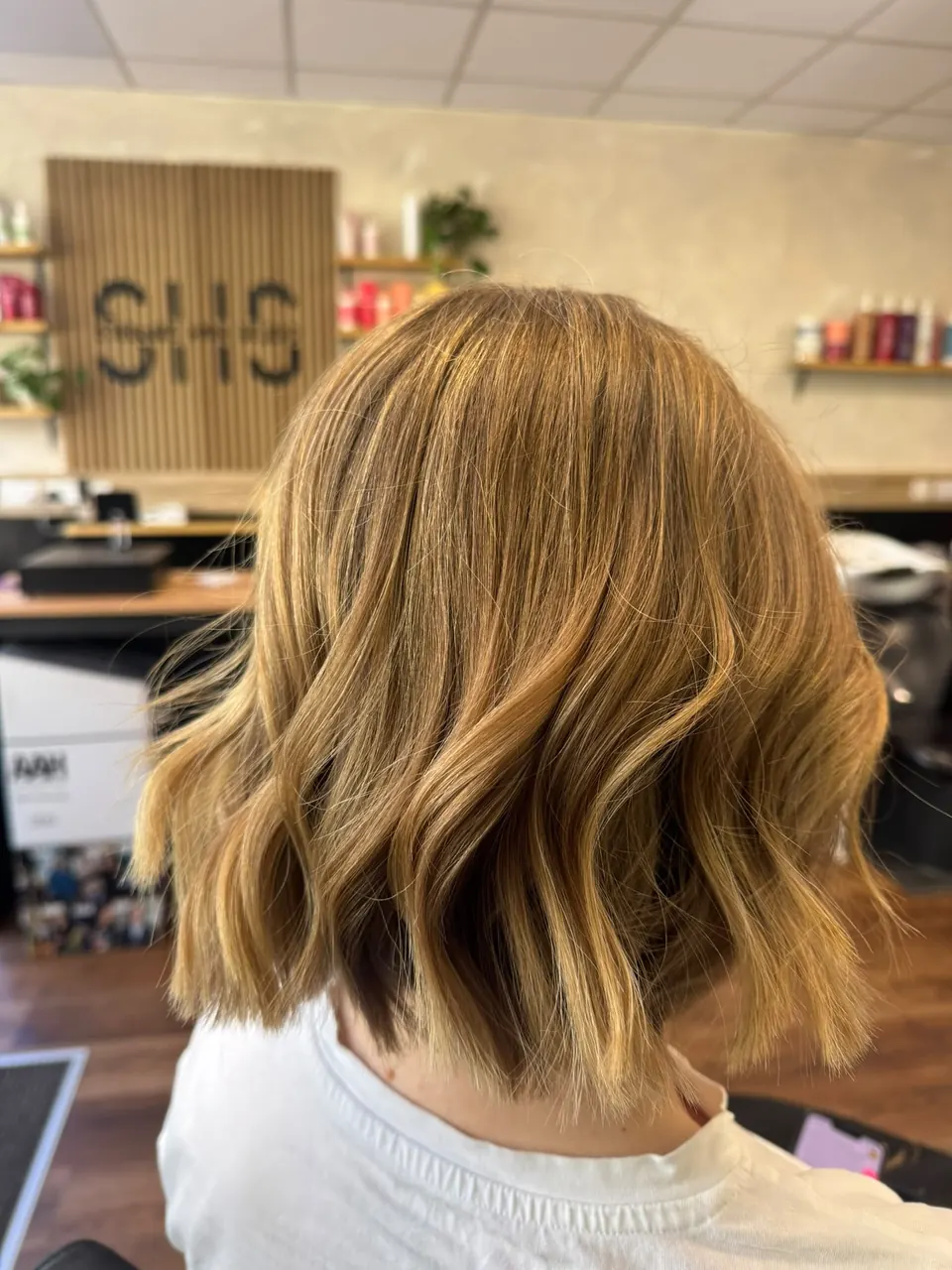 Bob with warm blonde balayage and beachy waves