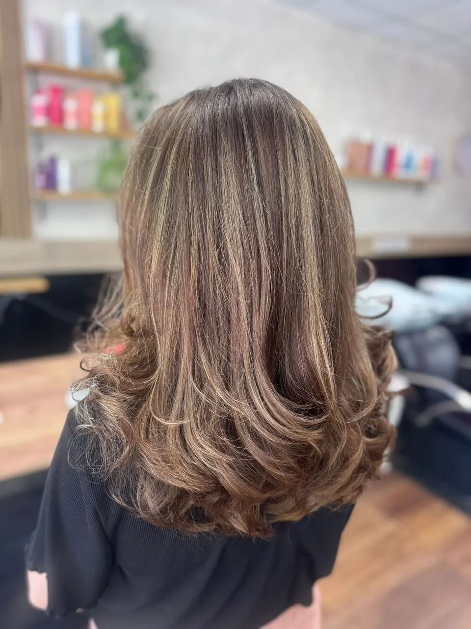 Brunette hair with soft highlights and a bouncy blow dry