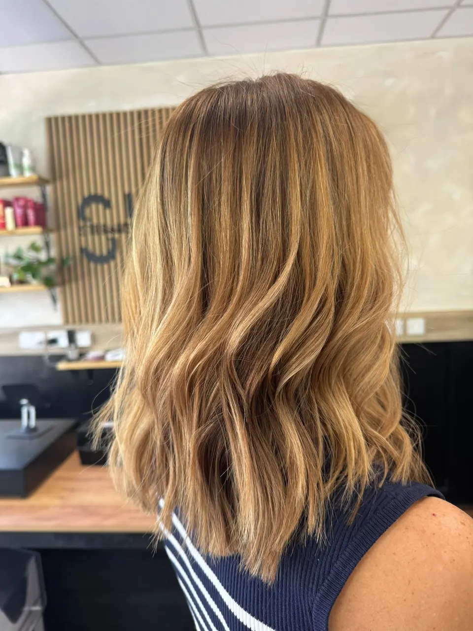 Caramel balayage on mid-length hair with soft waves