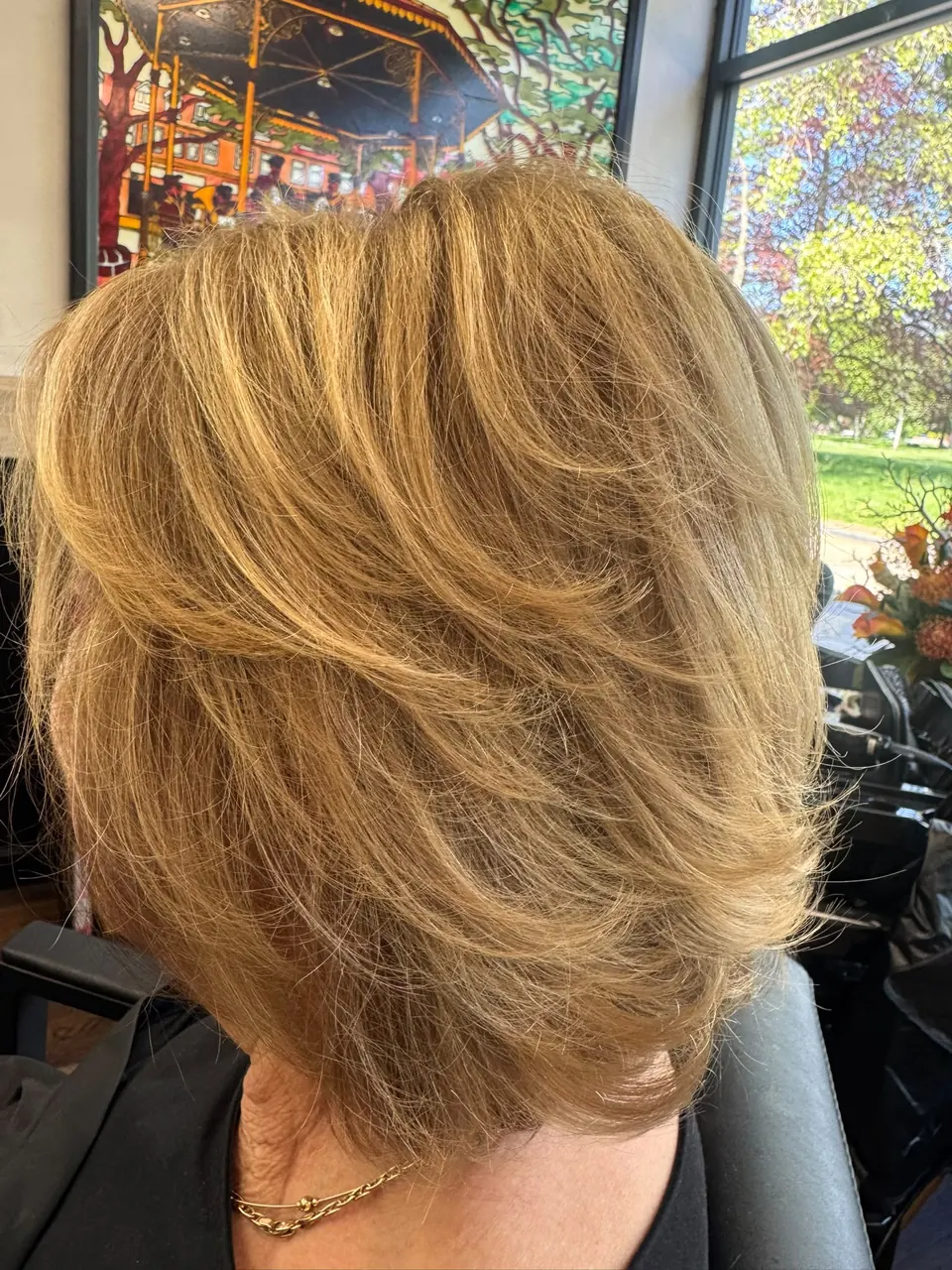 Golden blonde layered cut with a bouncy blow dry