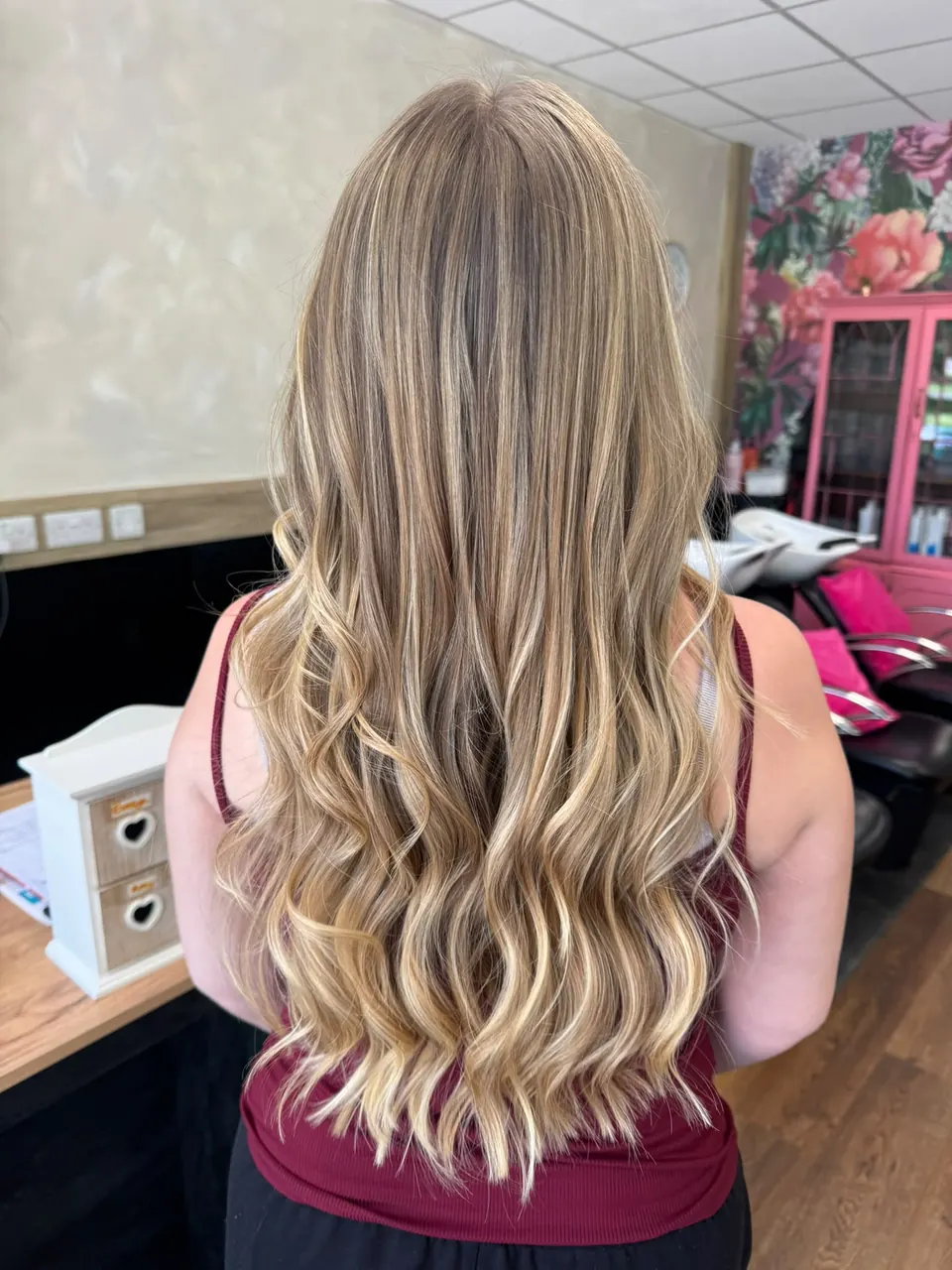 Long blonde balayage finished with soft, loose waves