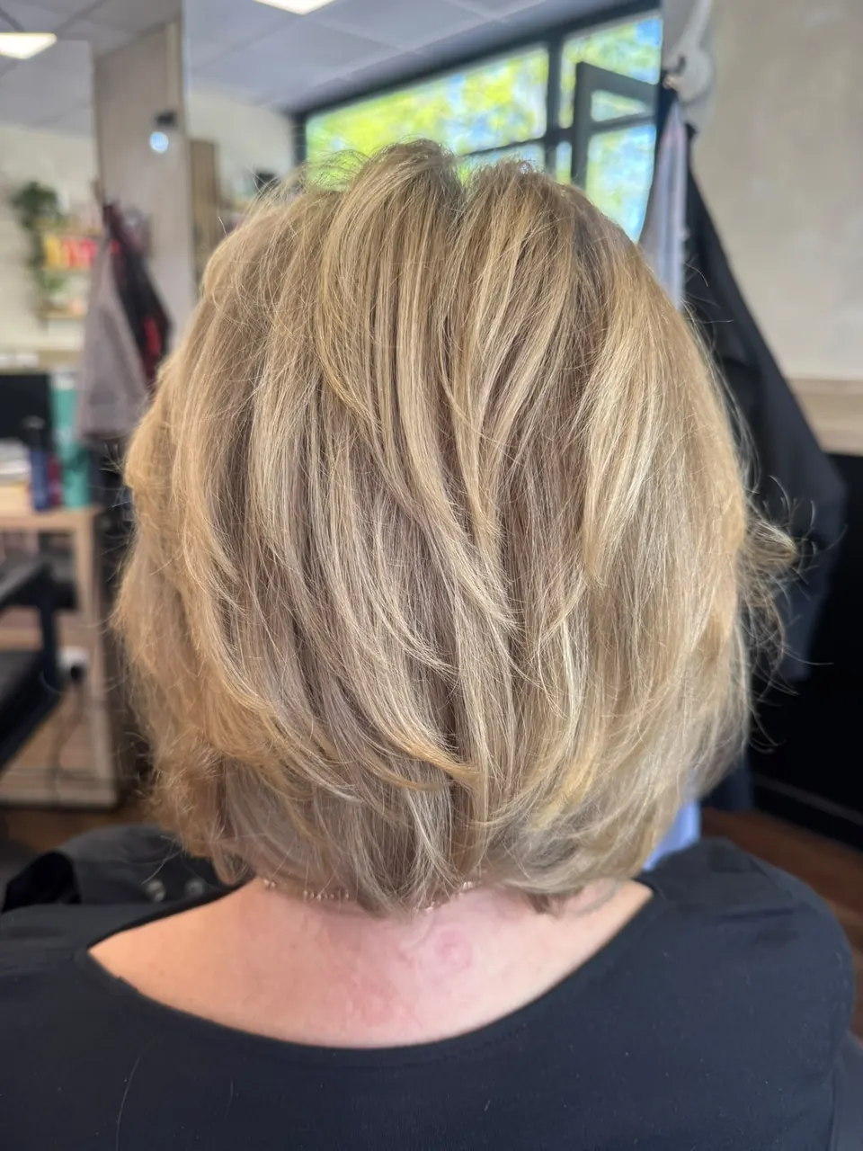 Short layered cut with blended blonde highlights