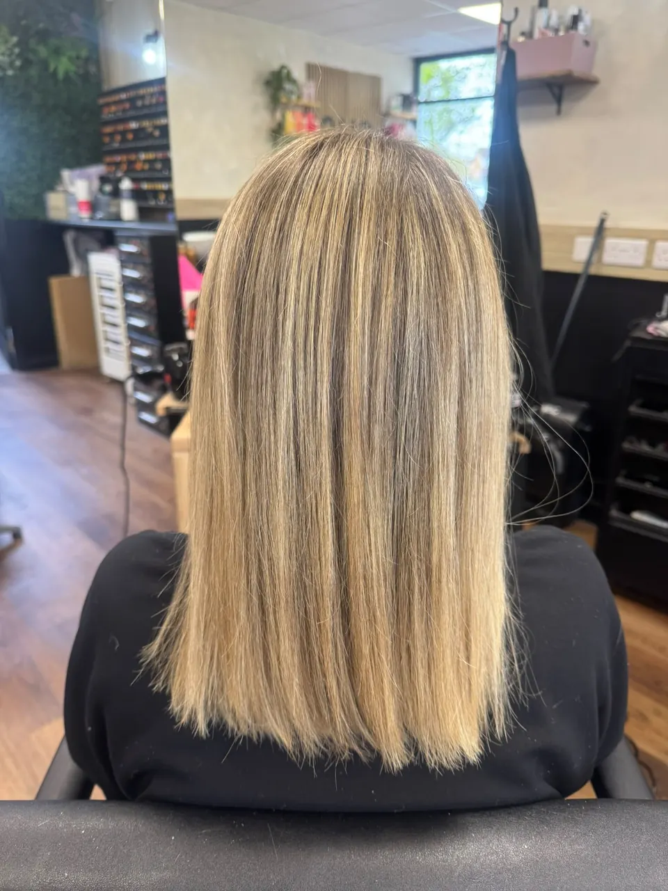 Sleek shoulder-length hair with fine blonde highlights
