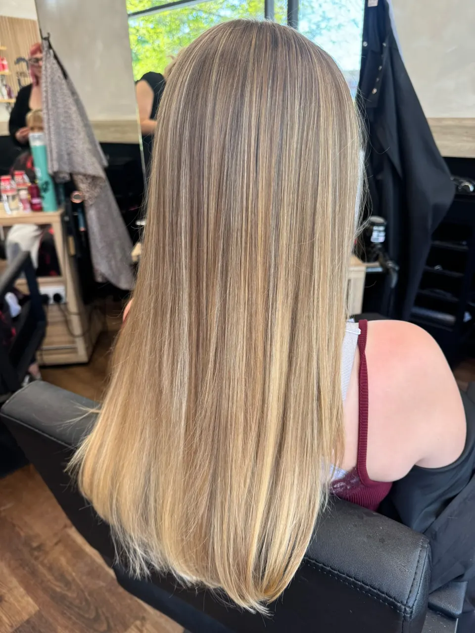 Sleek, straight long hair with a blended blonde balayage